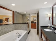 King Suite Bathroom with Mirror, Vanity, Bathtub, and Room Technology