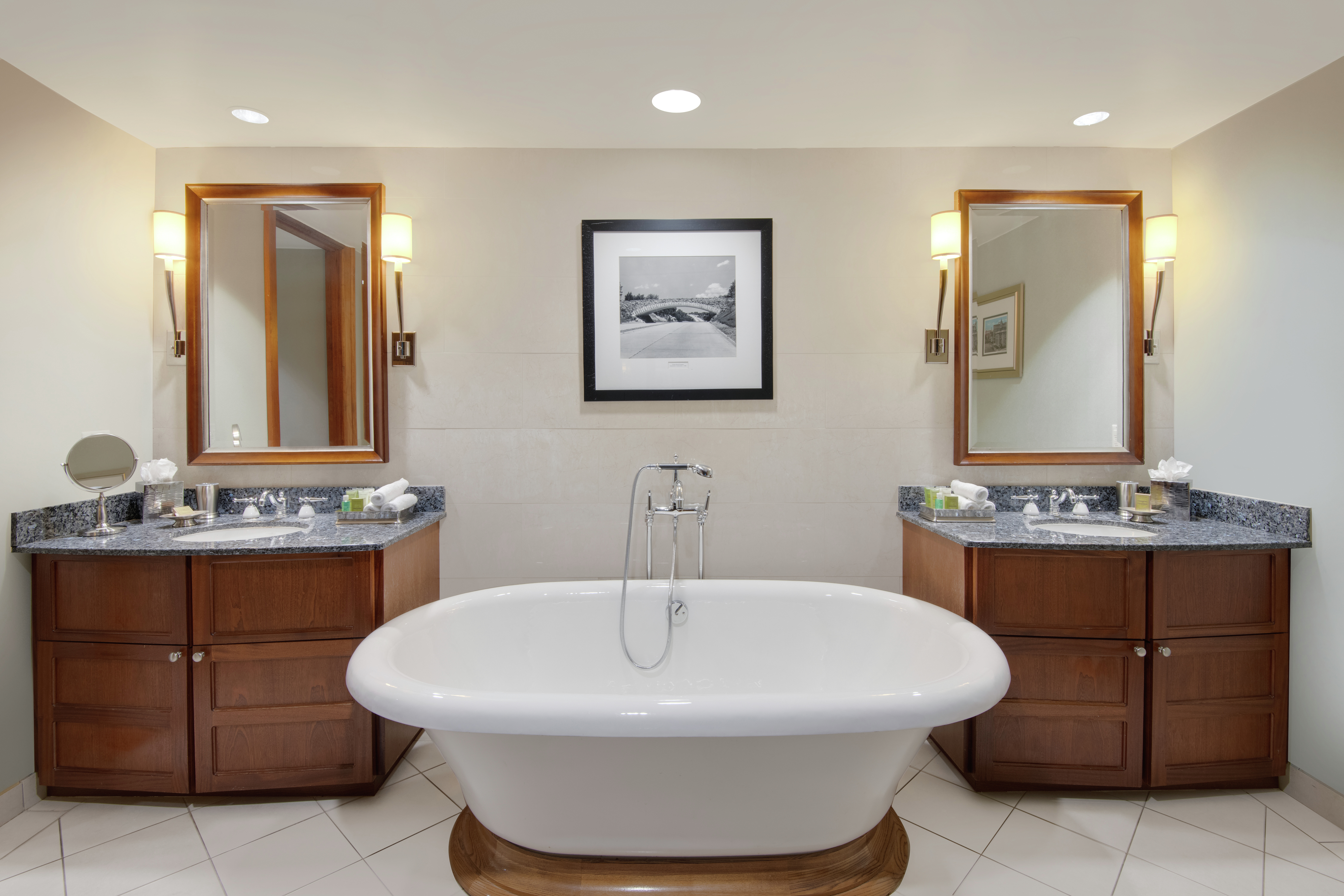 Presidential Suite Bathroom with Mirrors, Double Vanity, and Bathtub