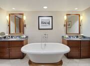 Presidential Suite Bathroom with Mirrors, Double Vanity, and Bathtub