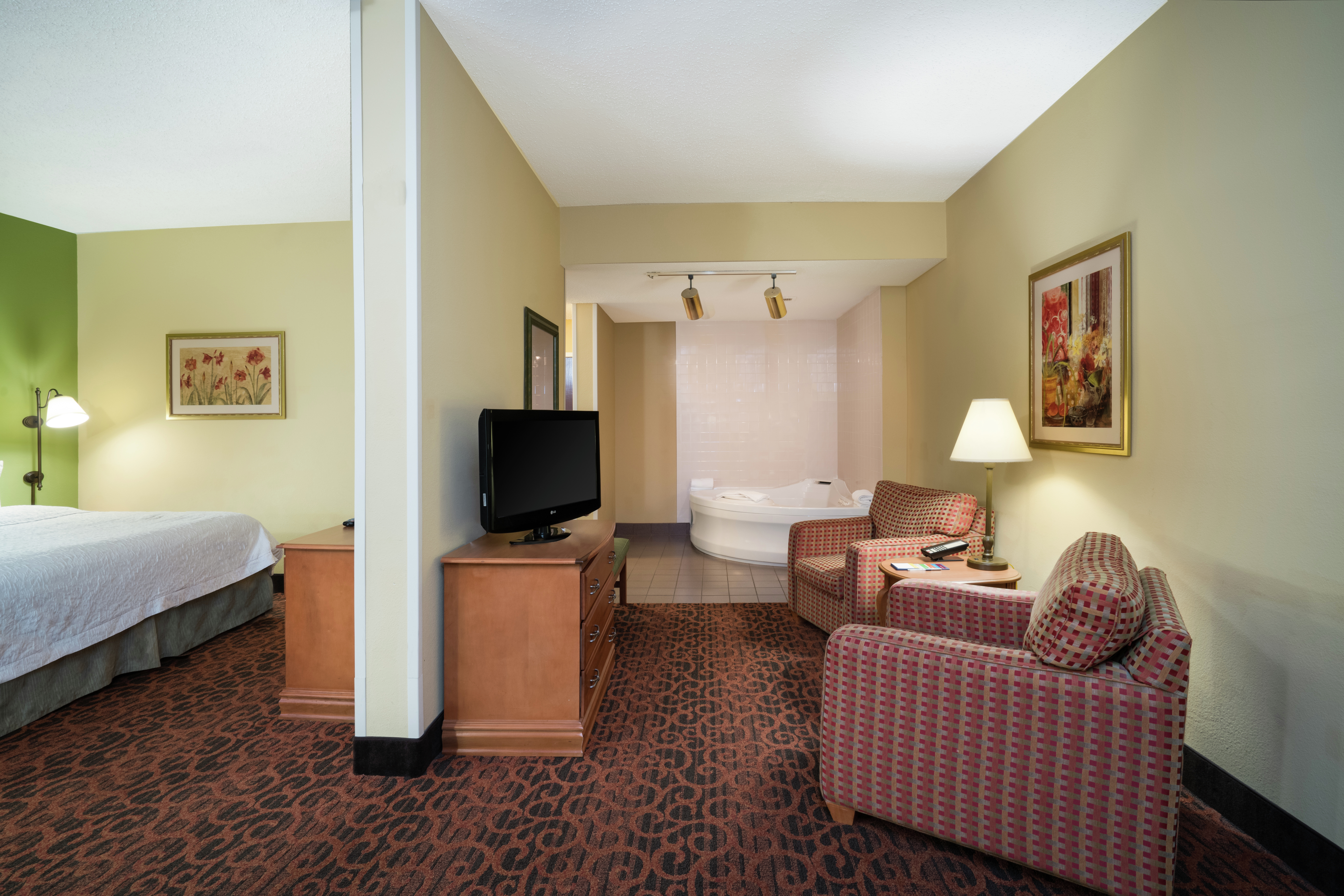 Suite with Lounge Area, TV, King Bed, and Jacuzzi