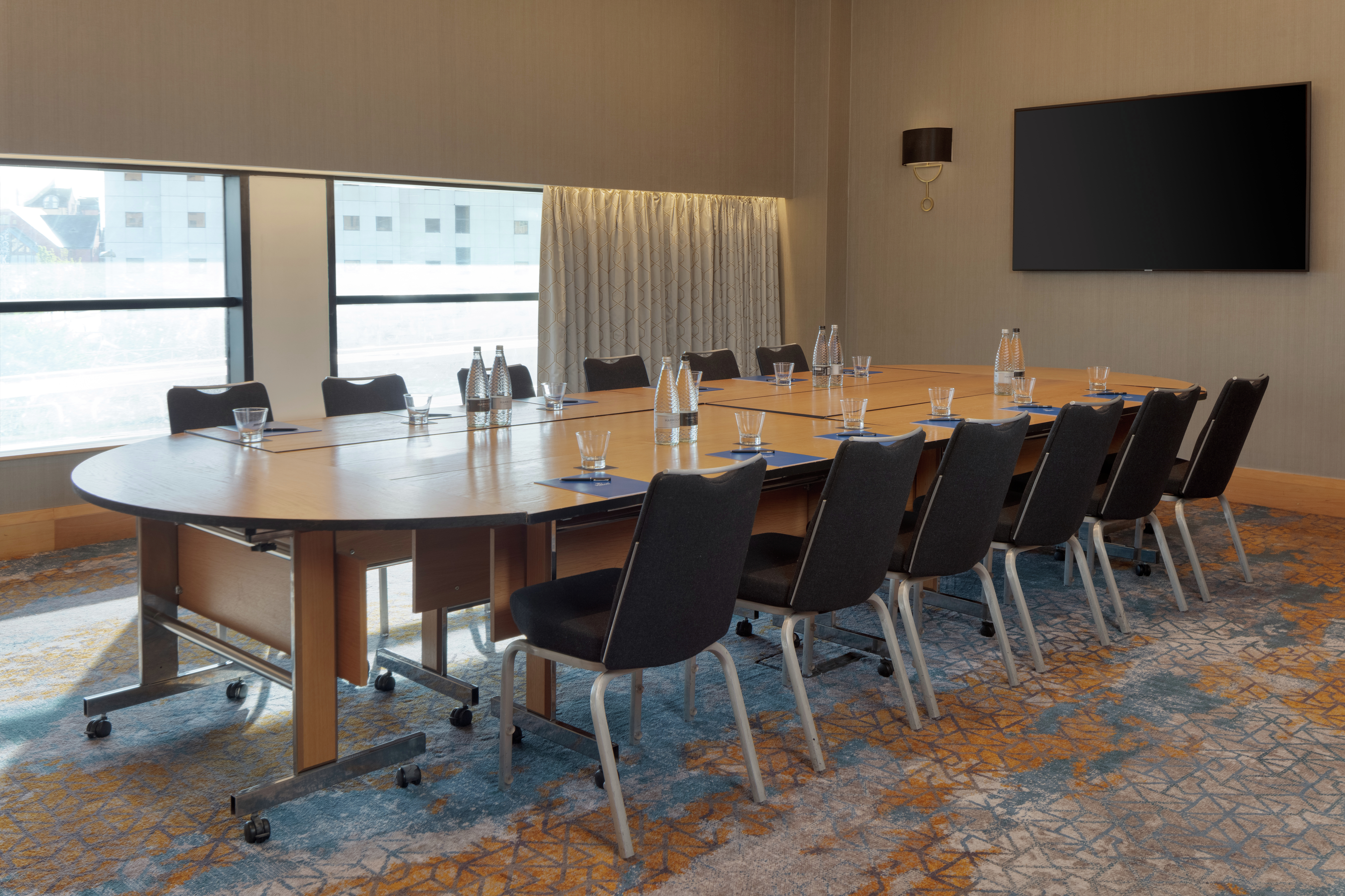 Side View of Boardroom with HDTV and Seating for 10 Guests