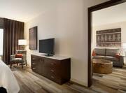Separate Bedroom in King Suite with HDTV, Sofa, Footrest and Armchair