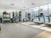 fitness equipment in a room with large windows