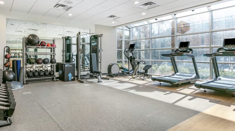 fitness equipment in a room with large windows