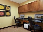 Business Center With Two Computer Workstations, Chairs, Wall Art, Overhead CAbinets, and Printer