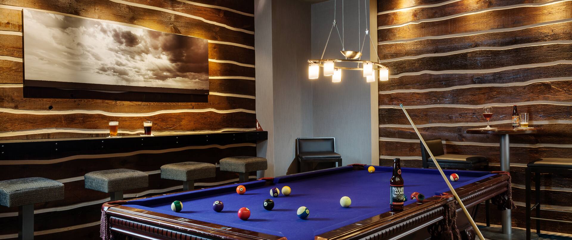 Montana's Lounge With Wall Art Above Counter Seating, Bar Table, Chairs and Pool Table