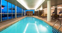 Indoor Swimming Pool With Lounge Seating and Windows