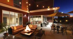Lounge Seating Around Fire Pit on Illuminated Outdoor Patio at NIght