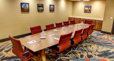 Wall Art and Seating for 12 Around Large Table in Boardroom Meeting Space