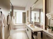 Guestroom Bathroom with Mirror, Dual Vanity, Robes, and Bathtub