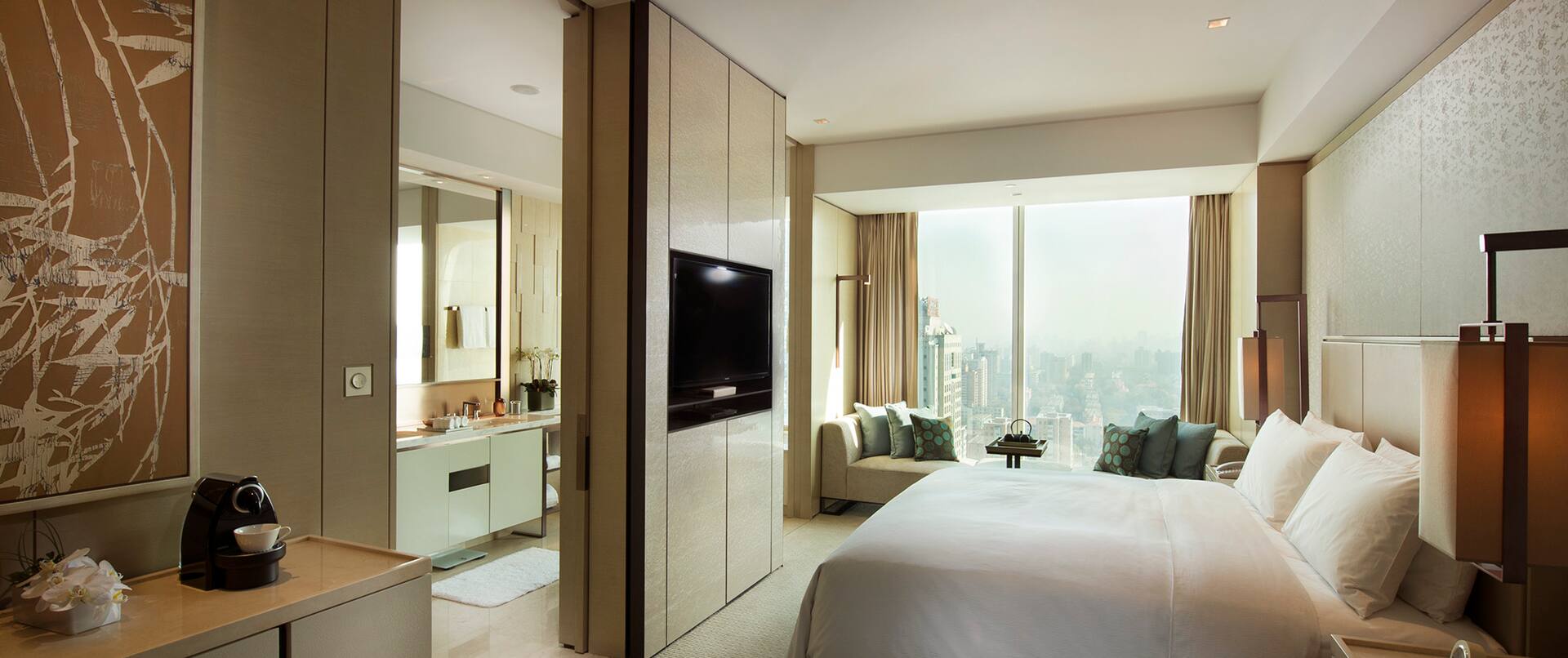 King-Sized Bed and Large Window in Deluxe Room
