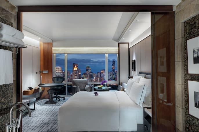 Premium Room Nightlight bedroom shot with cityscape