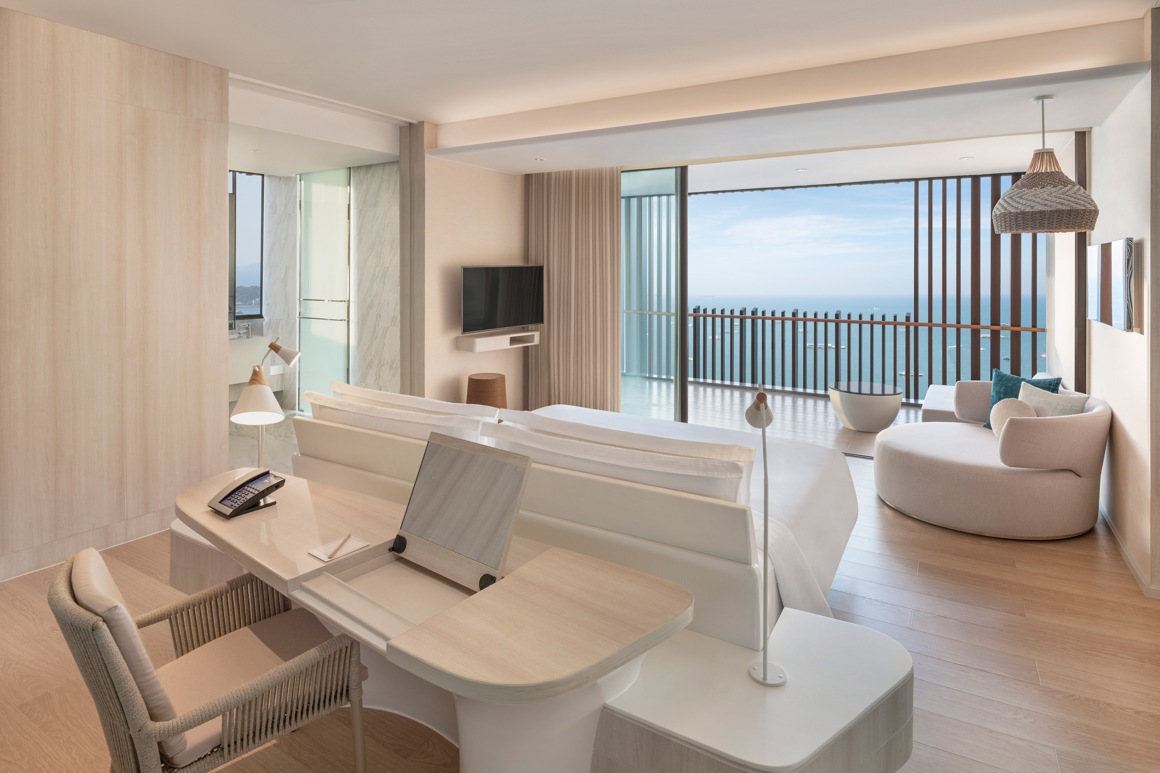Large Bed in Suite with Desk and Ocean View