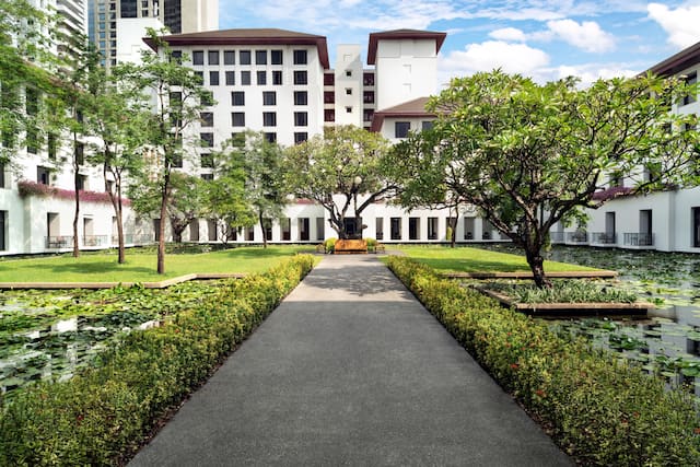 Courtyard of hotel with garden area and trees