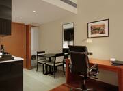 Premium room living area with workdesk and chairs