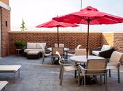 Outdoor Patio Area with Tables, Seats and Umbrellas
