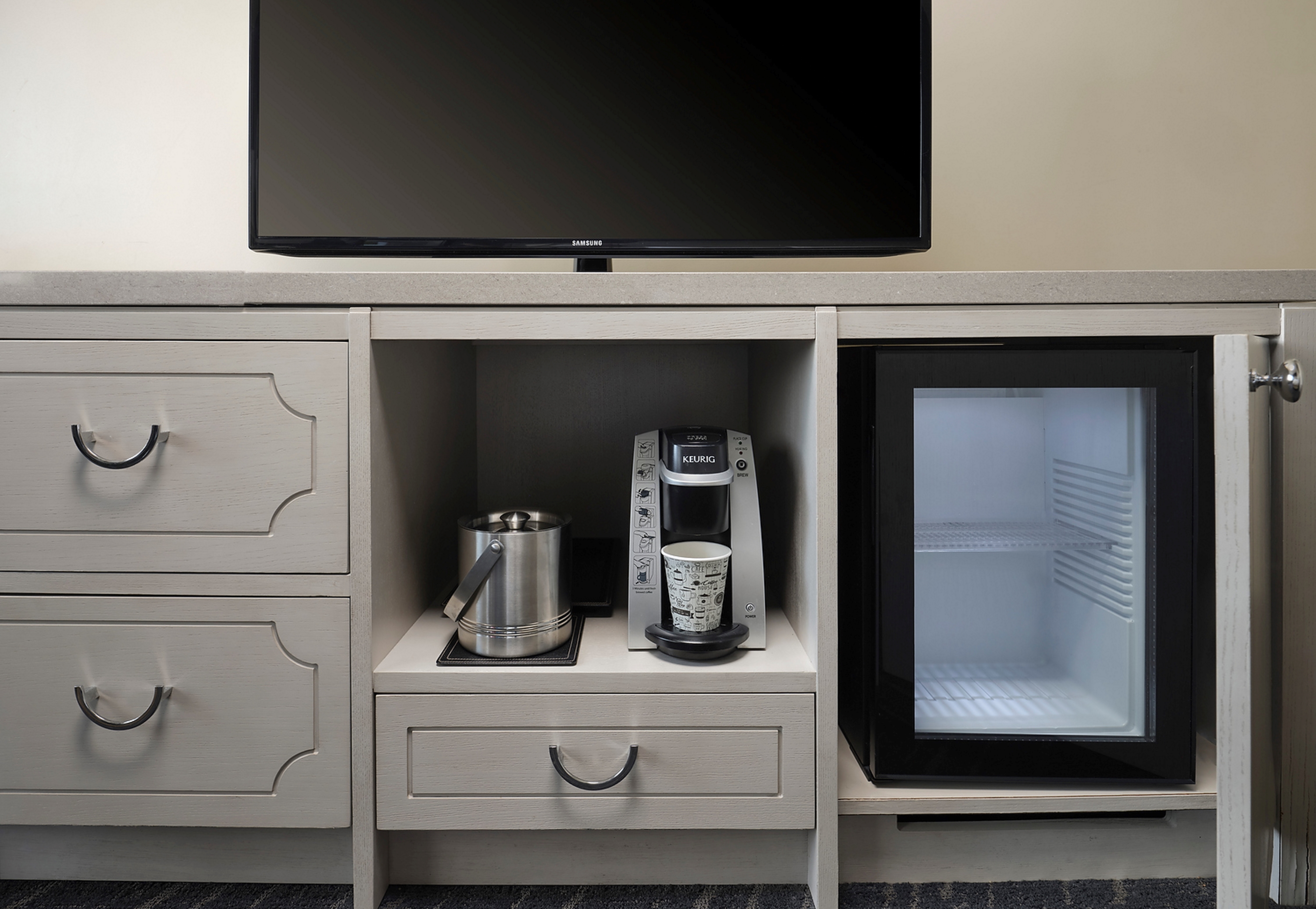 coffee station, mini fridge, and tv