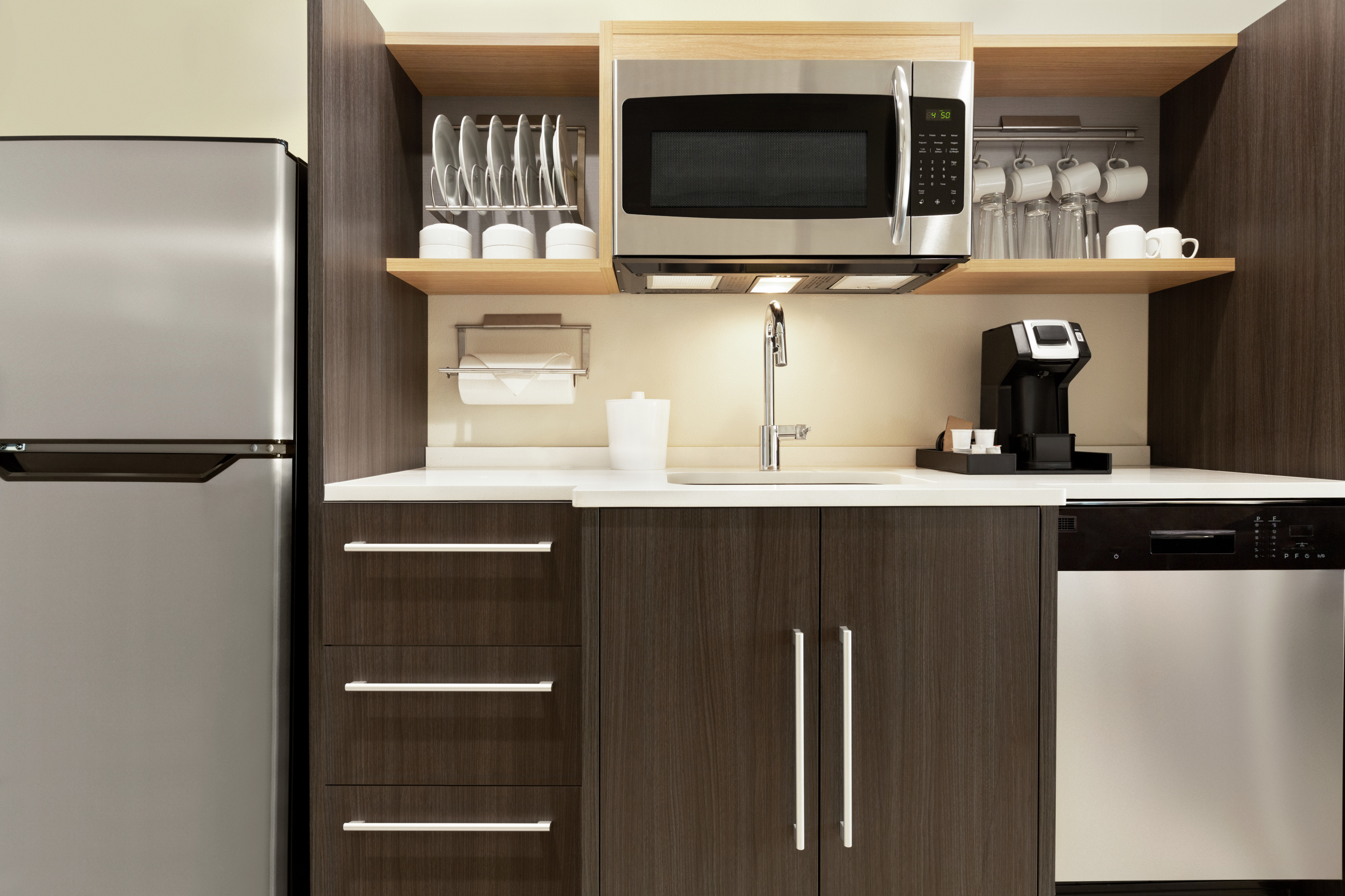 Convenient fully equipped in suite kitchen featuring fridge, dishwasher, and microwave.