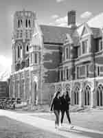 Students walking by a large historic building