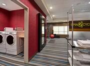 fitness center with laundry and towels
