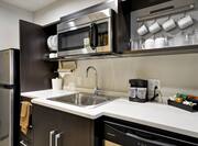 Guestroom Kitchen Counter with Microwave, Sink and Refridgerator