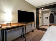  King-Sized Bed, Work Desk, and Television in Guest Room