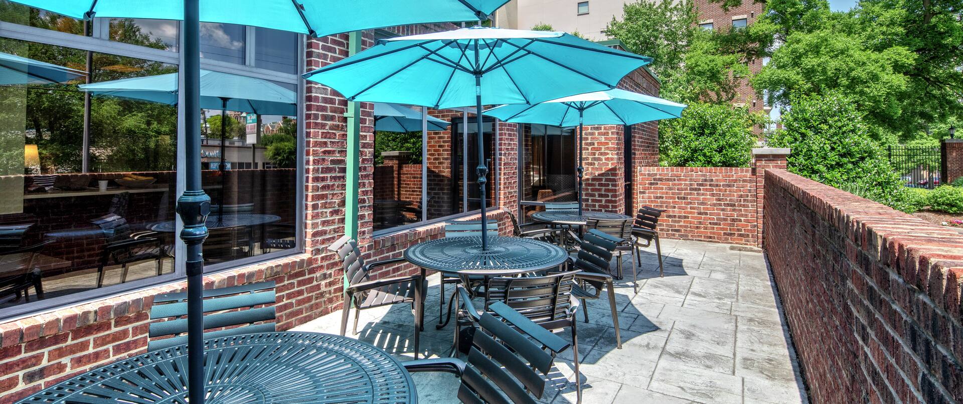 Outdoor Patio Common Area with Tables, Chairs and Large Shade Umbrellas