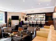 Bar Lounge Seating Area with Sofas, Chairs, Tables and Bar Counter