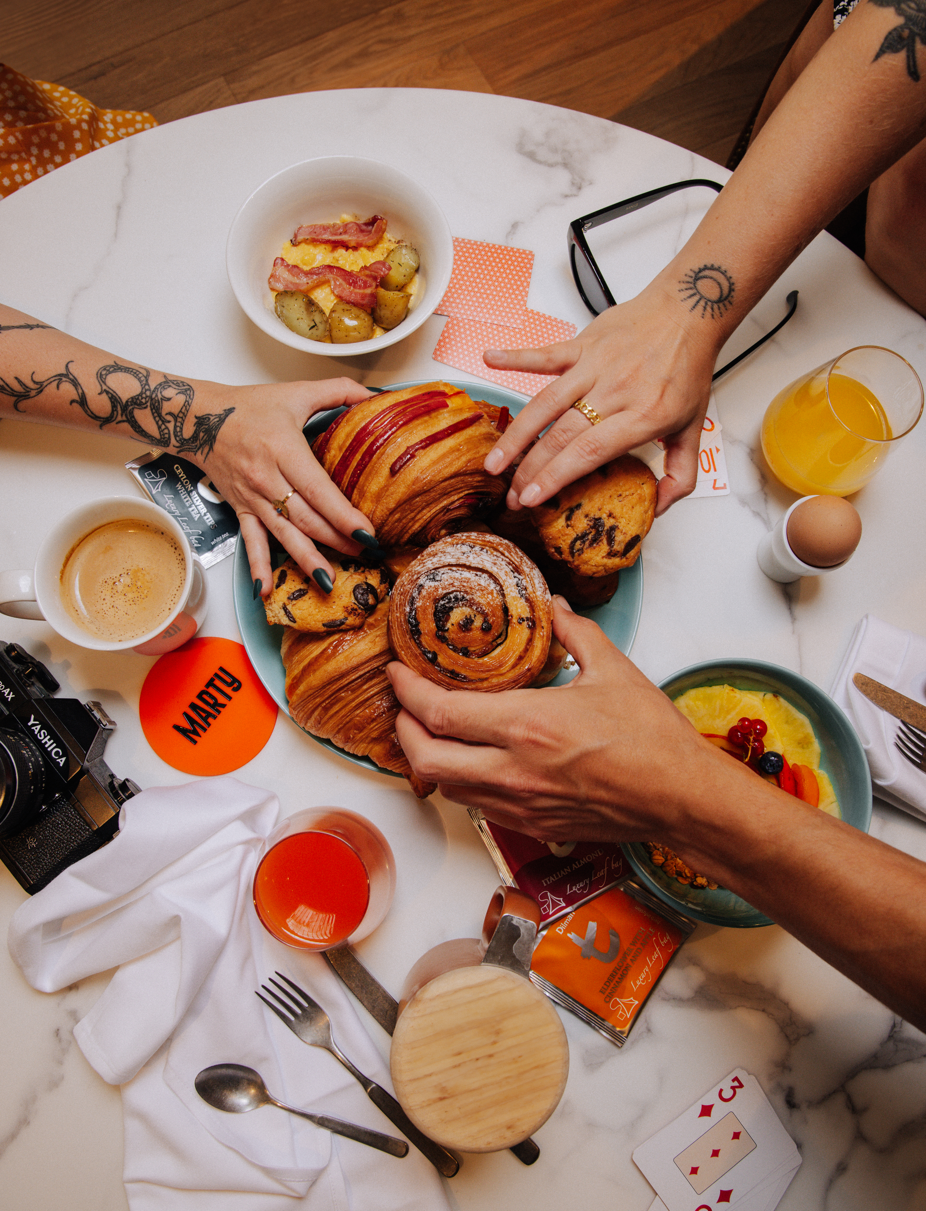 Overhead View of Guests Sharing Platter of Breakfast Pastries