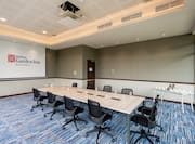 Meeting Room with Large Meeting Table, Office Chairs and Projector Screen