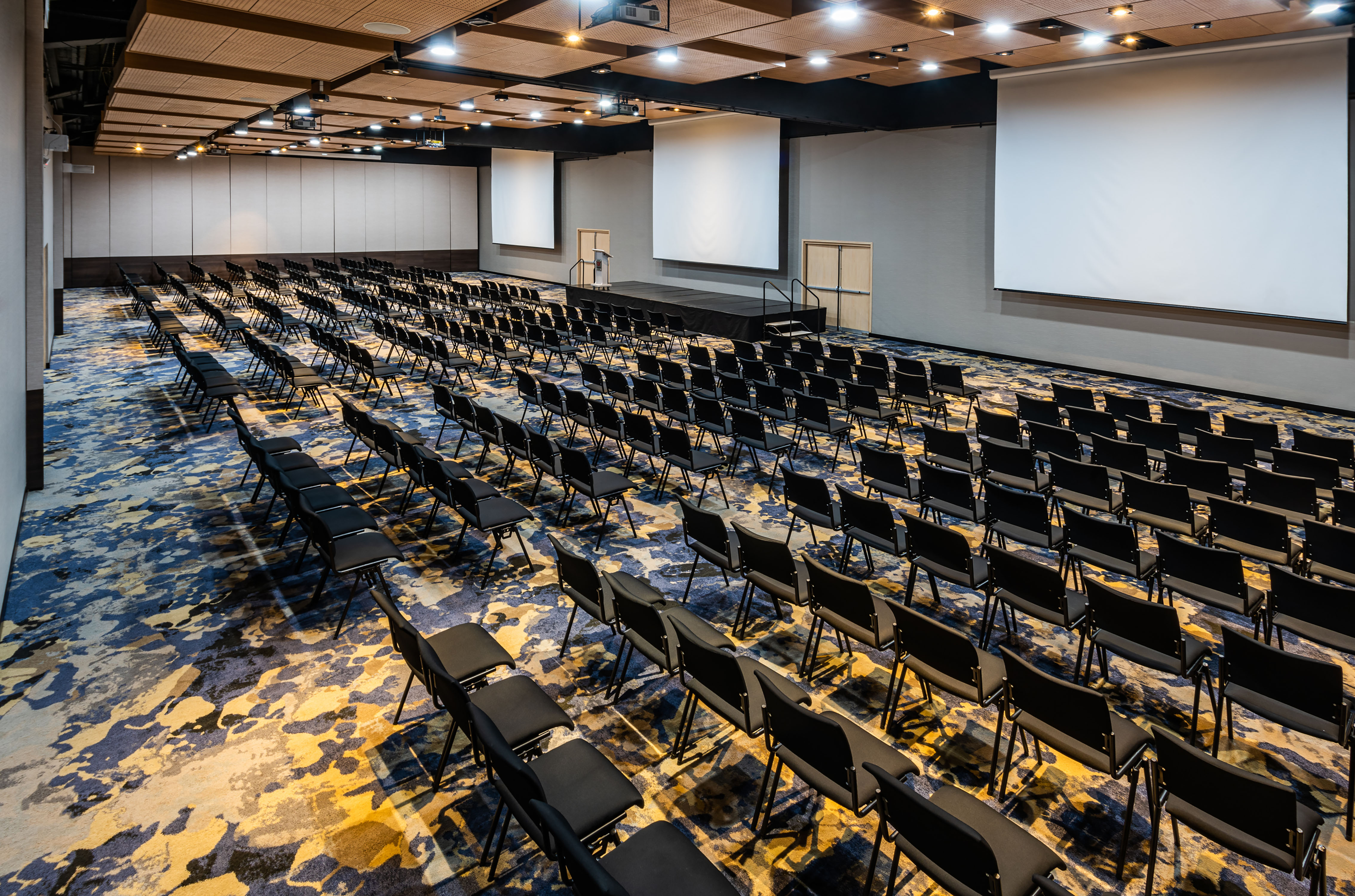 Large Meeting Room Setup Theater Style with Three Projection Screens