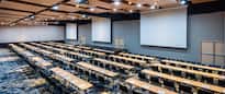 Large Meeting Room Setup Classroom Style with Three Projection Screens