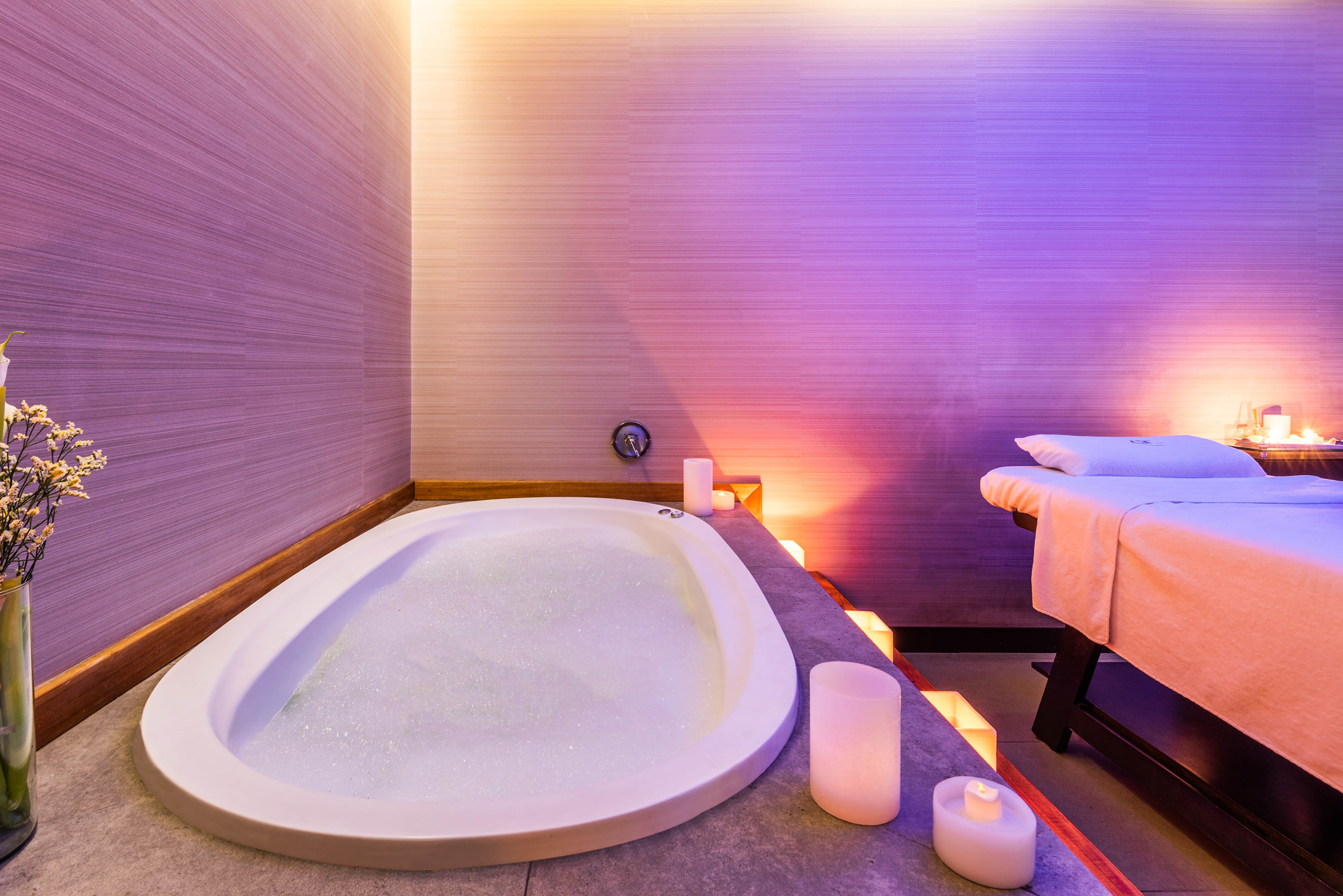 bubble bath with candles next to massage bed