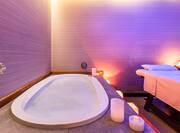 bubble bath with candles next to massage bed