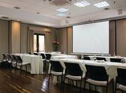 Small MEeting Room with Tables and Chairs Facing Projector