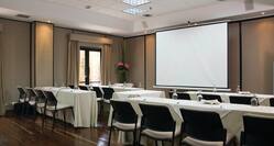 Small MEeting Room with Tables and Chairs Facing Projector