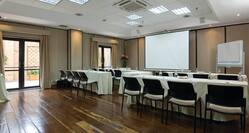 Meeting Room with Tables and Chairs Facing Projector