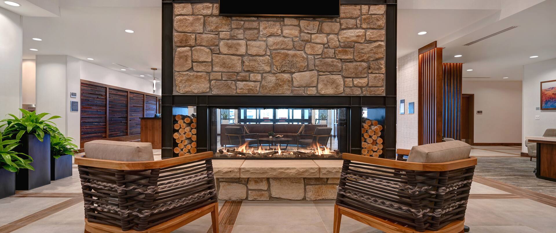 lobby lodge seating area with fireplace and television