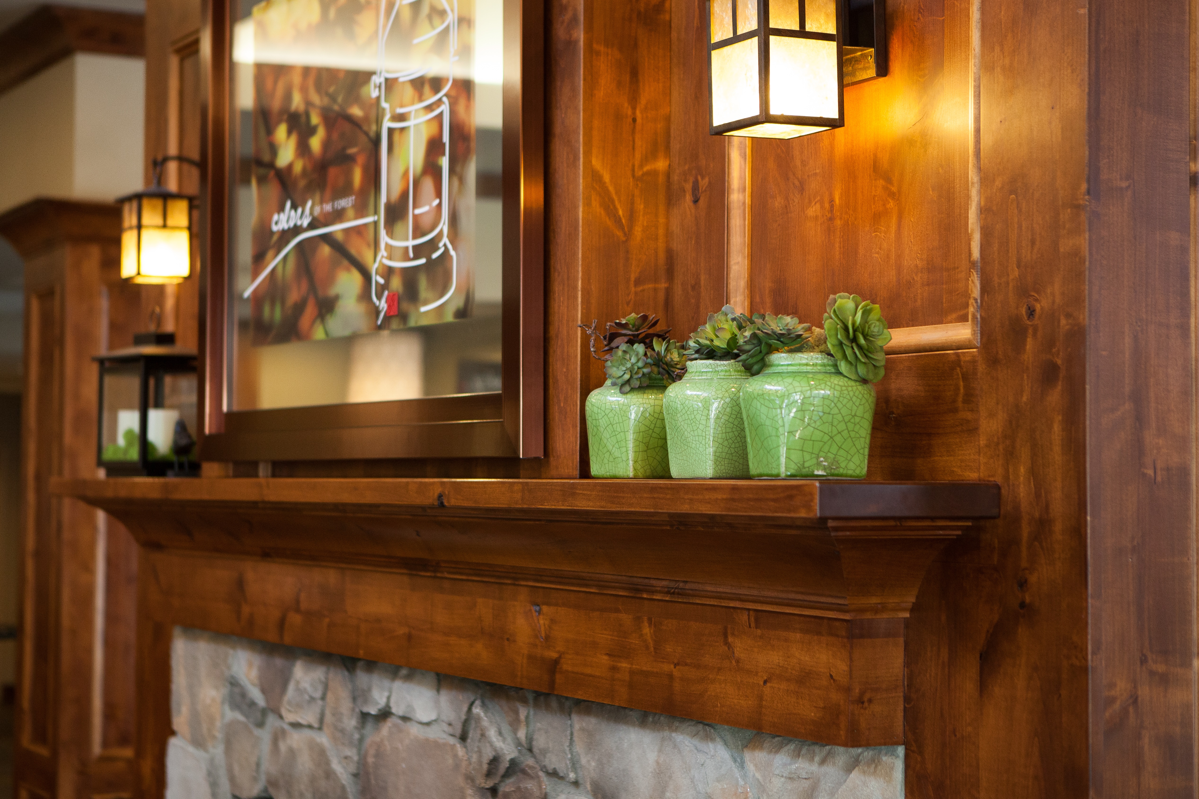 Decorative Flowers in Green Pots on Lobby Fireplace Mantle