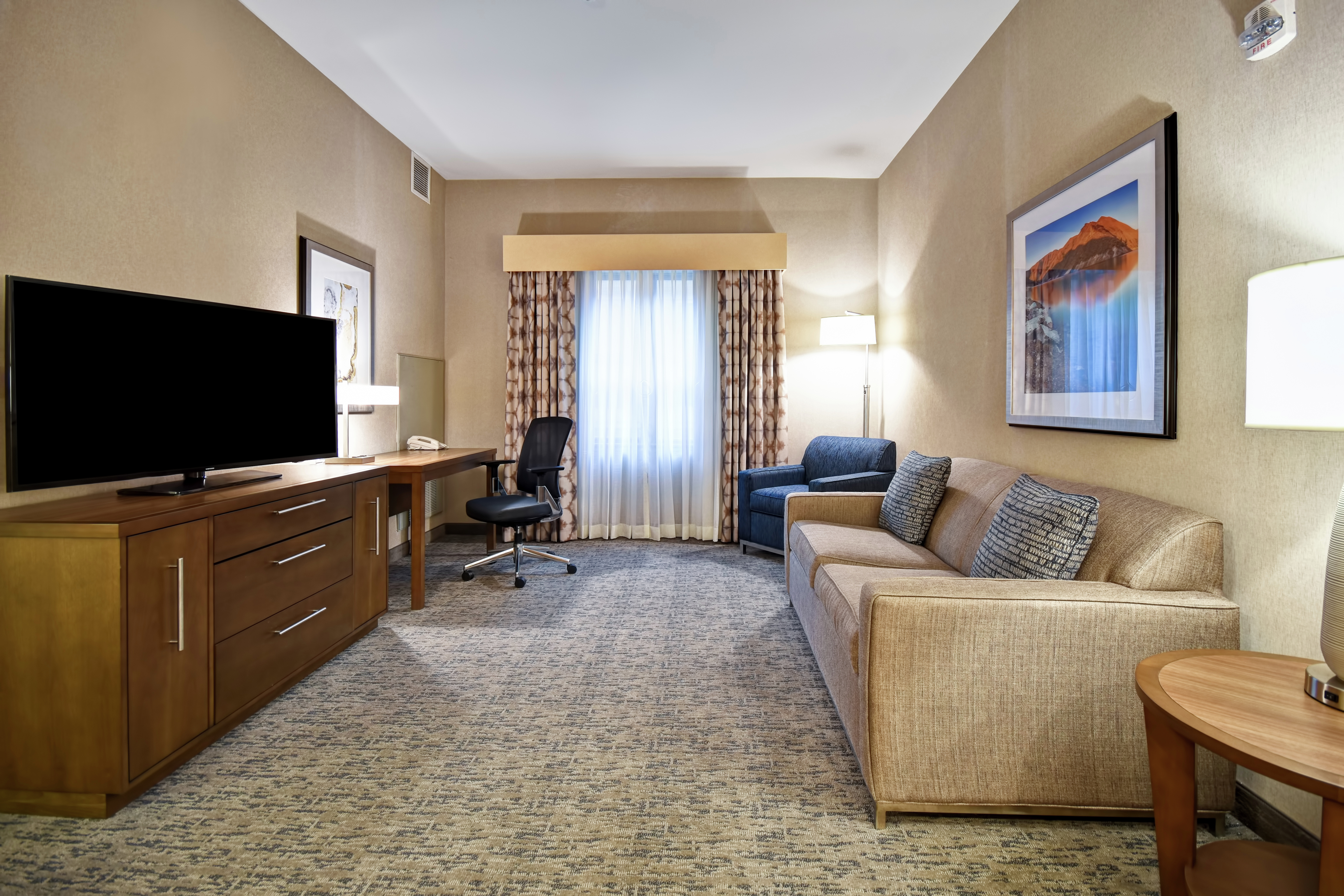 Suite Living Area with Lounge Furniture, Work Desk, and TV