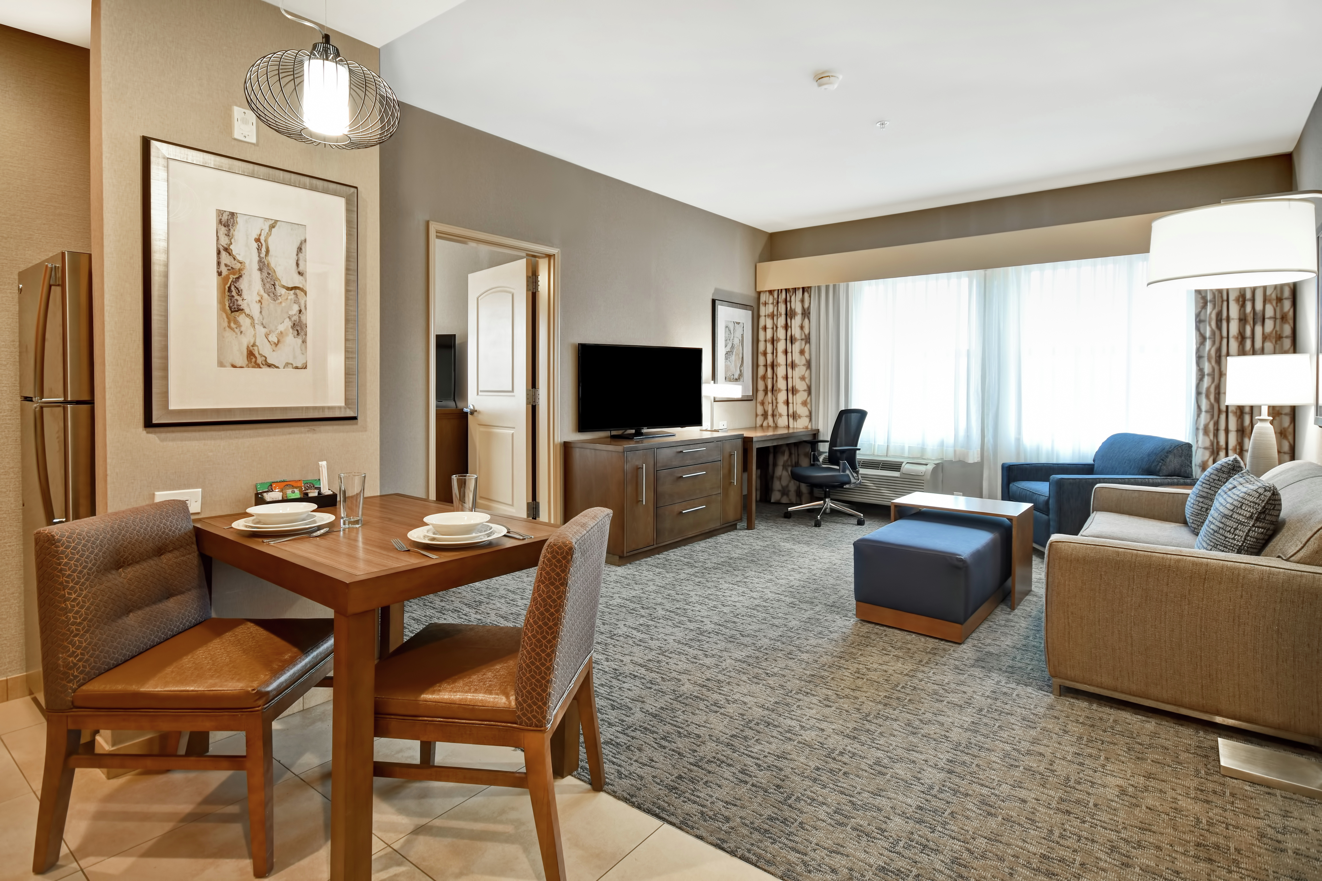 Suite Living Area with Dining Table, Lounge Furniture, TV, and Work Desk