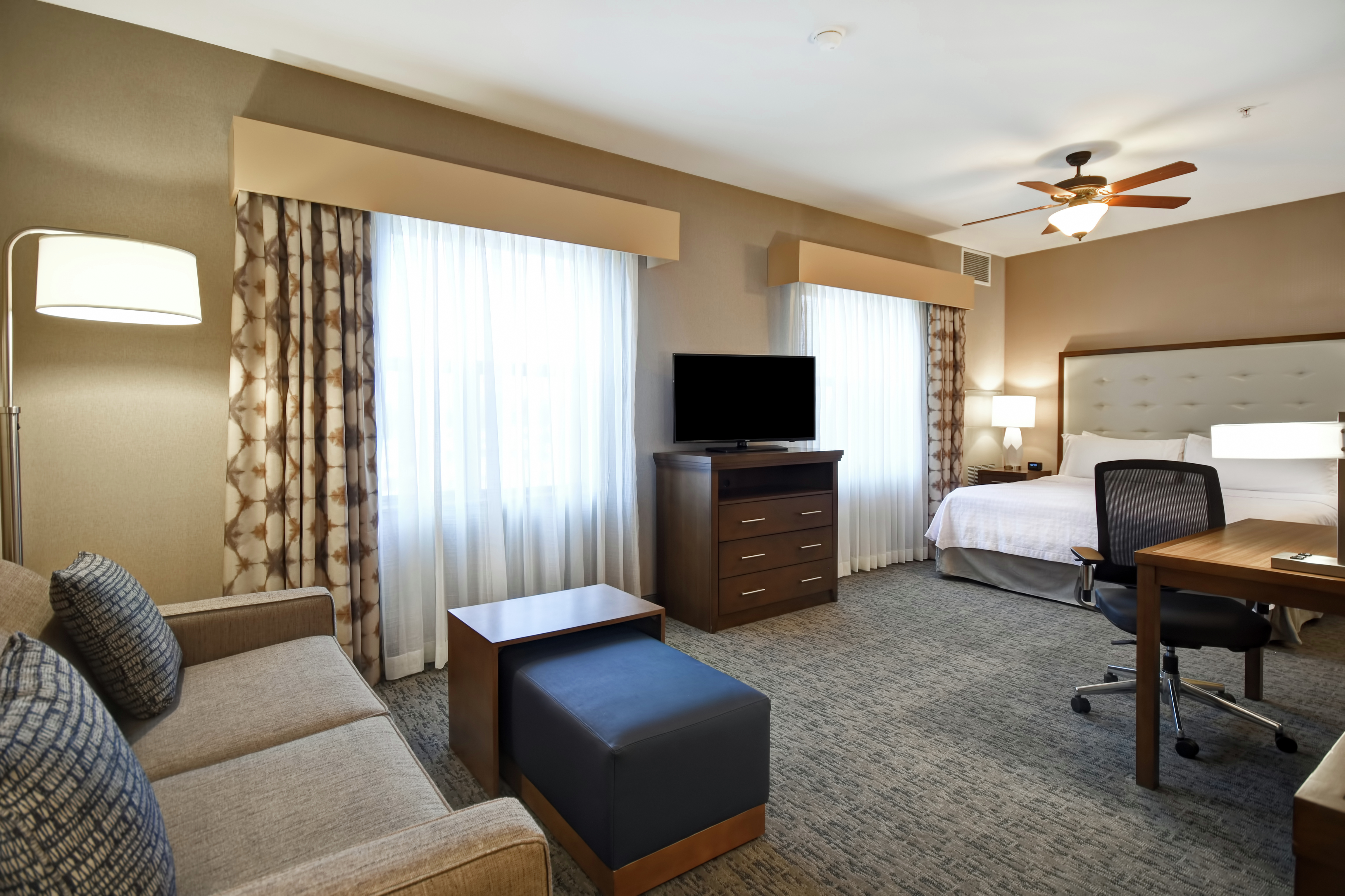 Lounge Area, TV, Work Desk, and Bed in Guest Suite