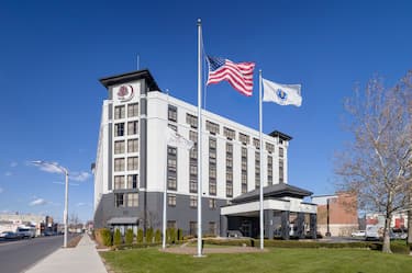 Hotel Building Exterior with Flag Poles at Noon