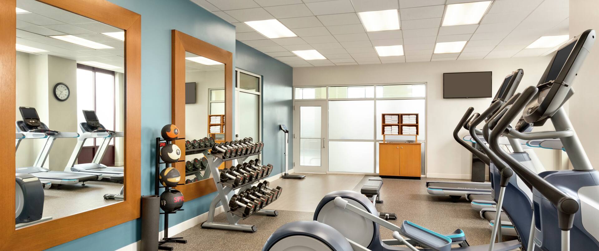 Fitness Center with Treadmills Recumbent Bikes and Weights Area