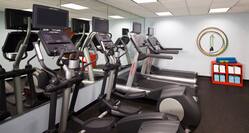 Fitness center with cardio machines and towel area