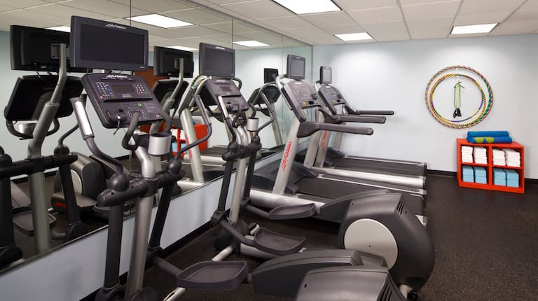 Fitness center with cardio machines and towel area