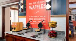 Breakfast Serving Area with Fresh Fruits and Wafflemakers