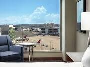King Bed Hotel Guestroom With Airport View