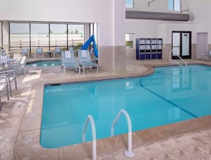 indoor pool and whirlpool with lounge chairs 