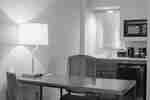 A desk, chair and wetbar in a guest room